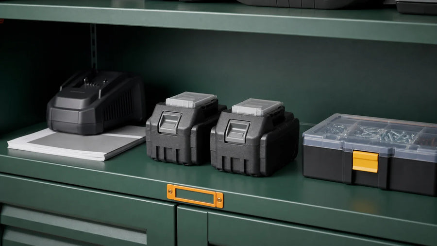 Intact cordless tool batteries stored on a clean shelf away from loose metal hardware and direct heat.